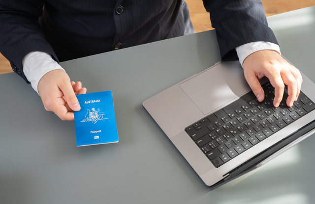 Client holding a newly received U.S. passport processed with help from Expert Multi-Services San Jose