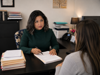 Rosa Gafare privately collecting a client's intake information in San Jose